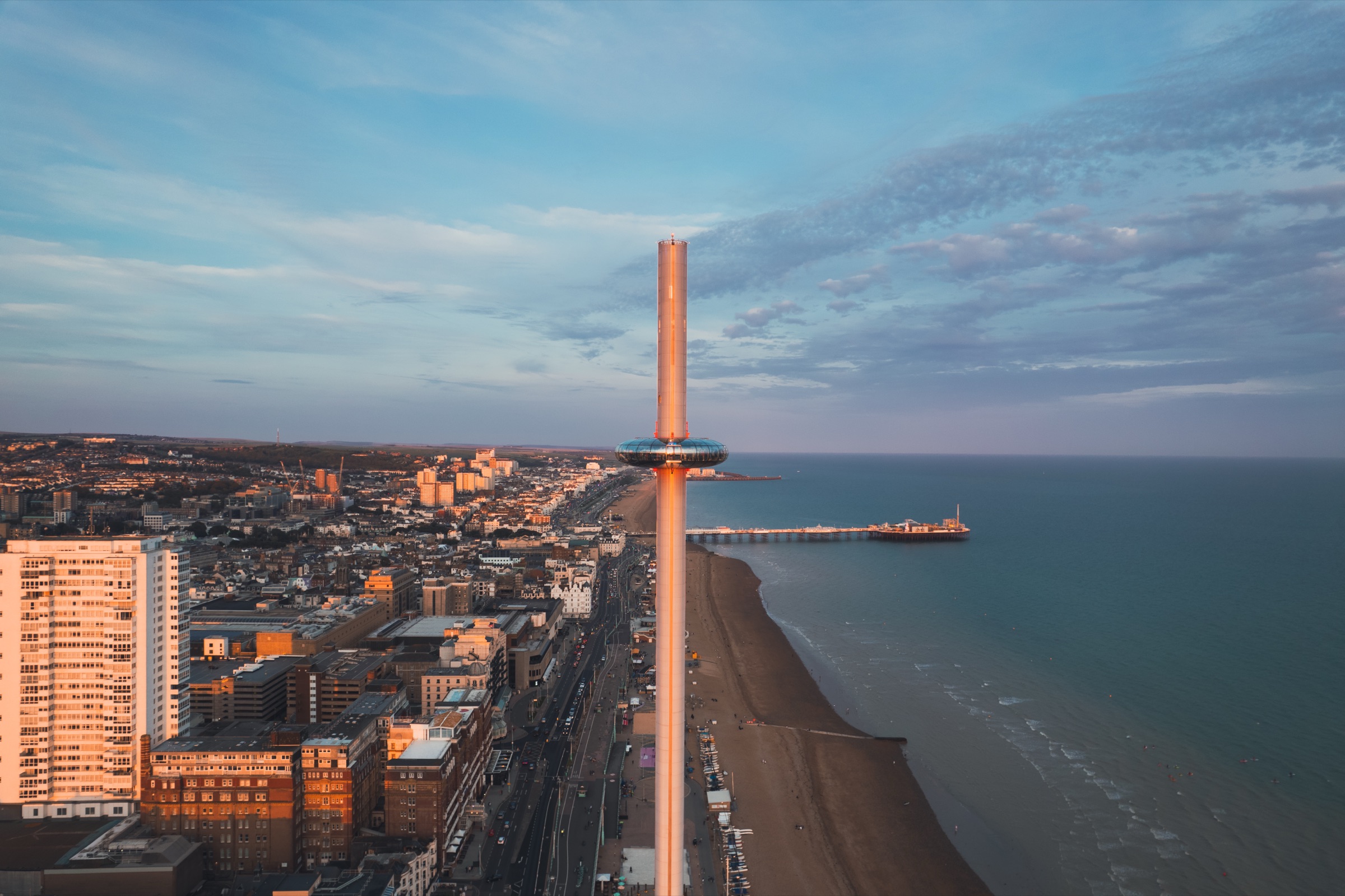 Aerial drone photograph of Brighton seafront and Palace Pier at golden hour